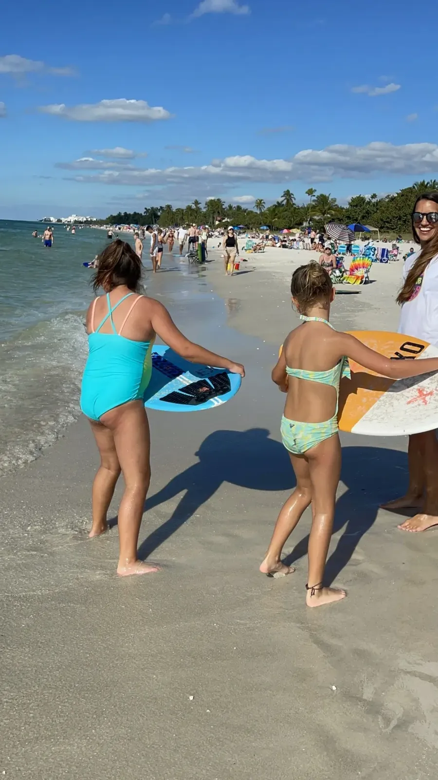 kids learning to skim board by naples pier, naples florida