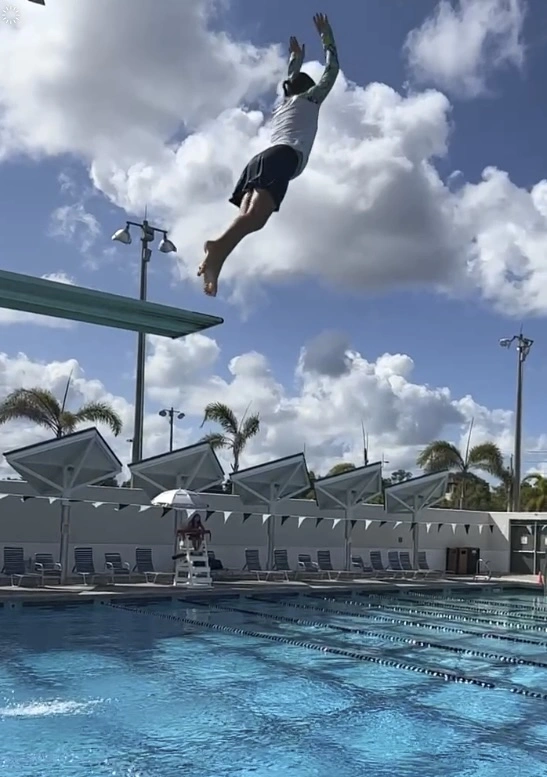 kid jumping of diving board river park aquatic center